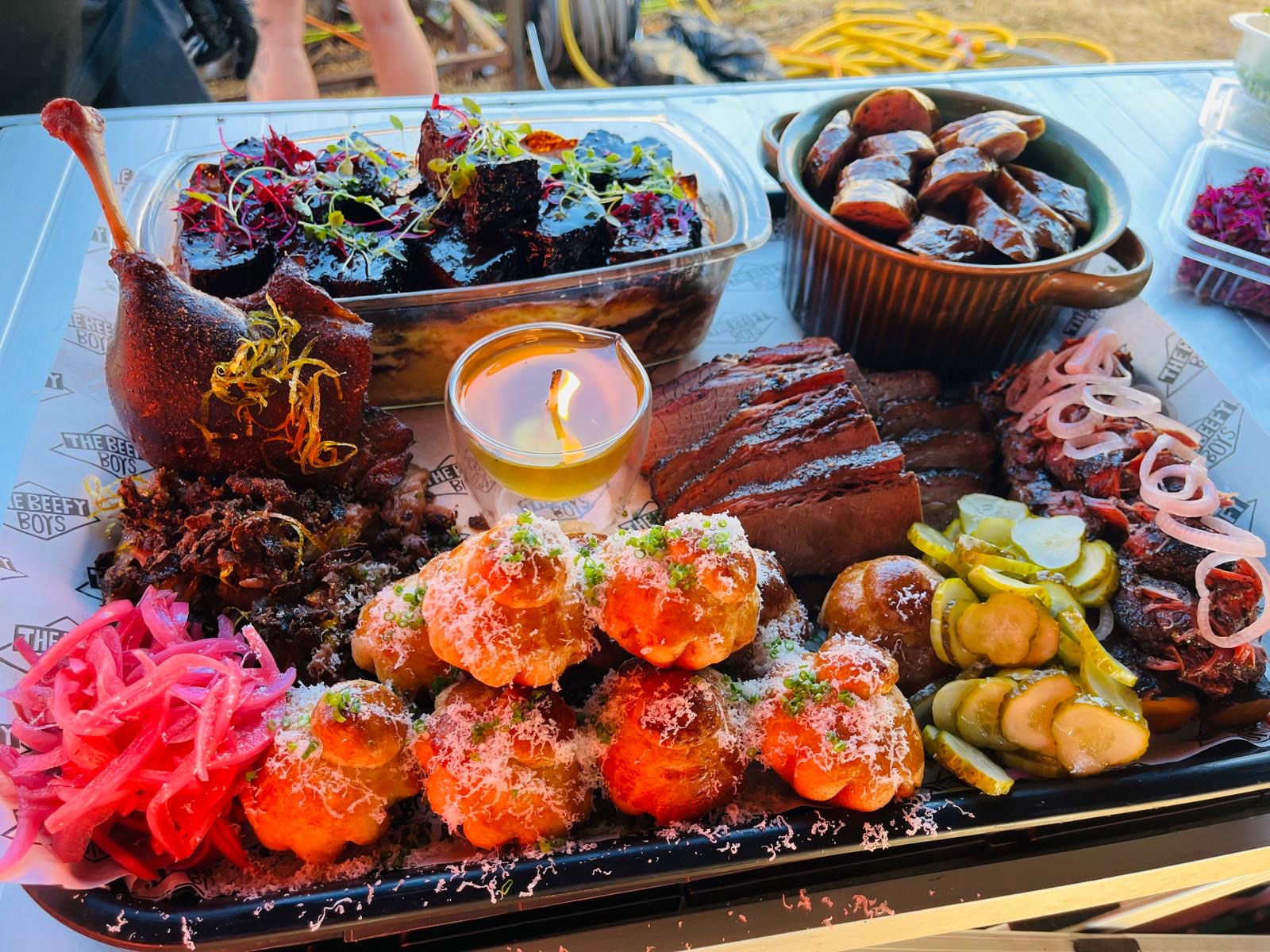 Competition barbecue platter with brisket, smoked meats, pickles and sides