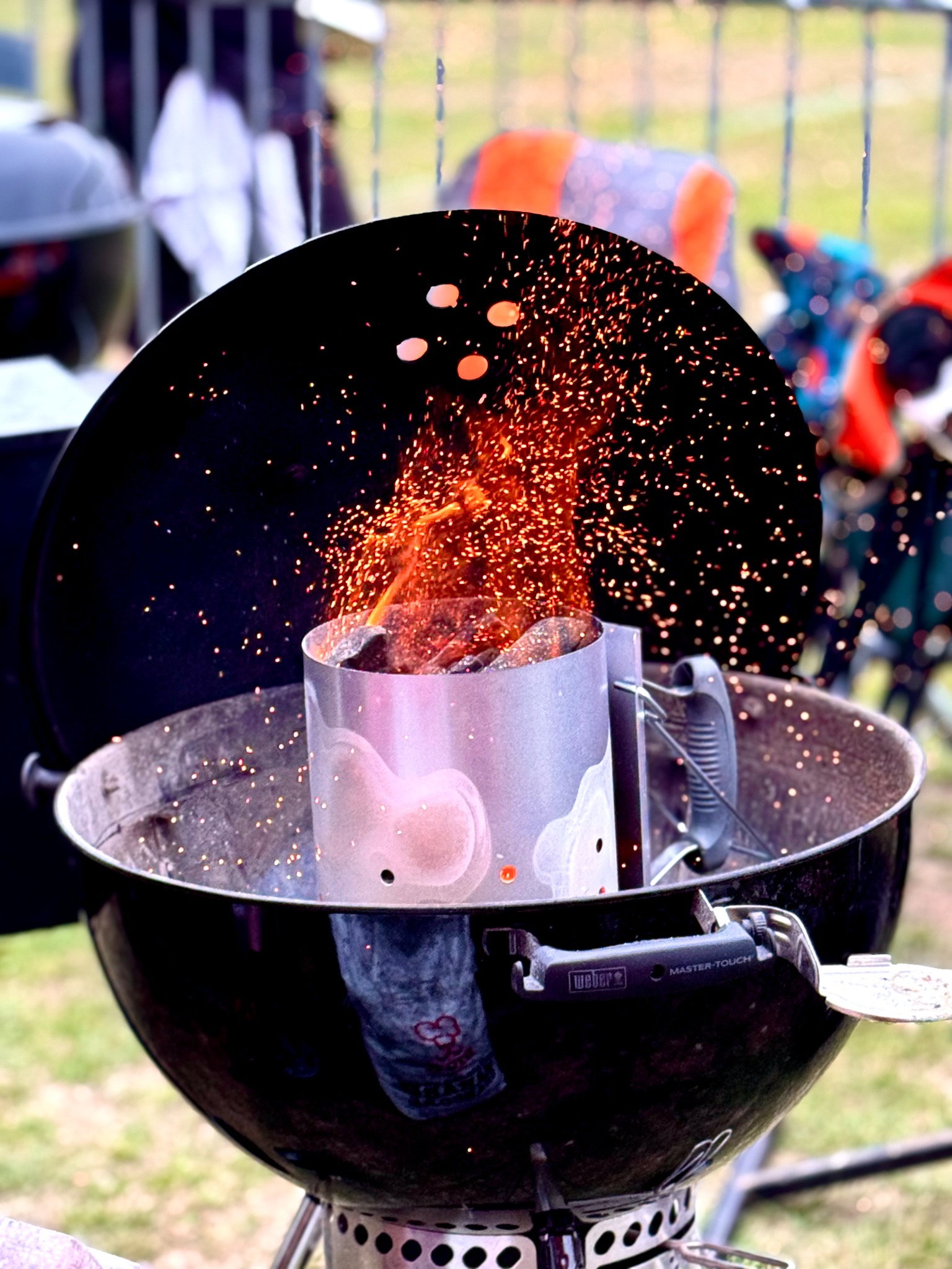 Sparks rising as charcoal is lit for the barbecue