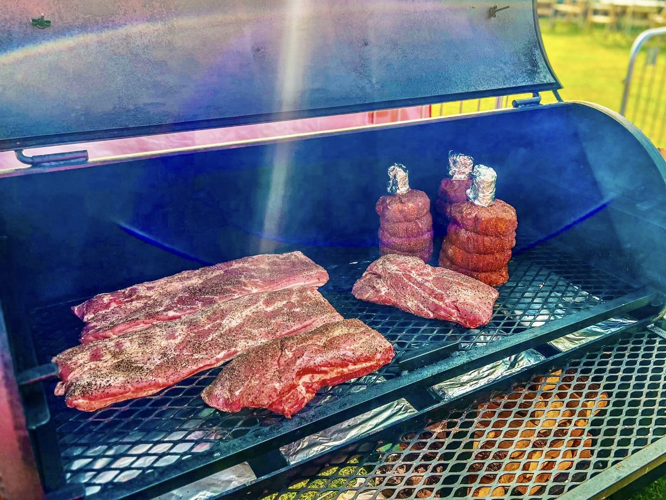 Seasoned meat at the start of a cook in the smoker